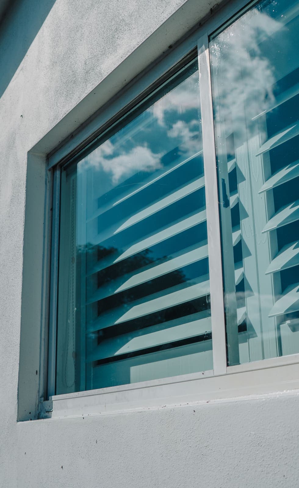 Impact window over plantation shutters on a Miami-Dade home