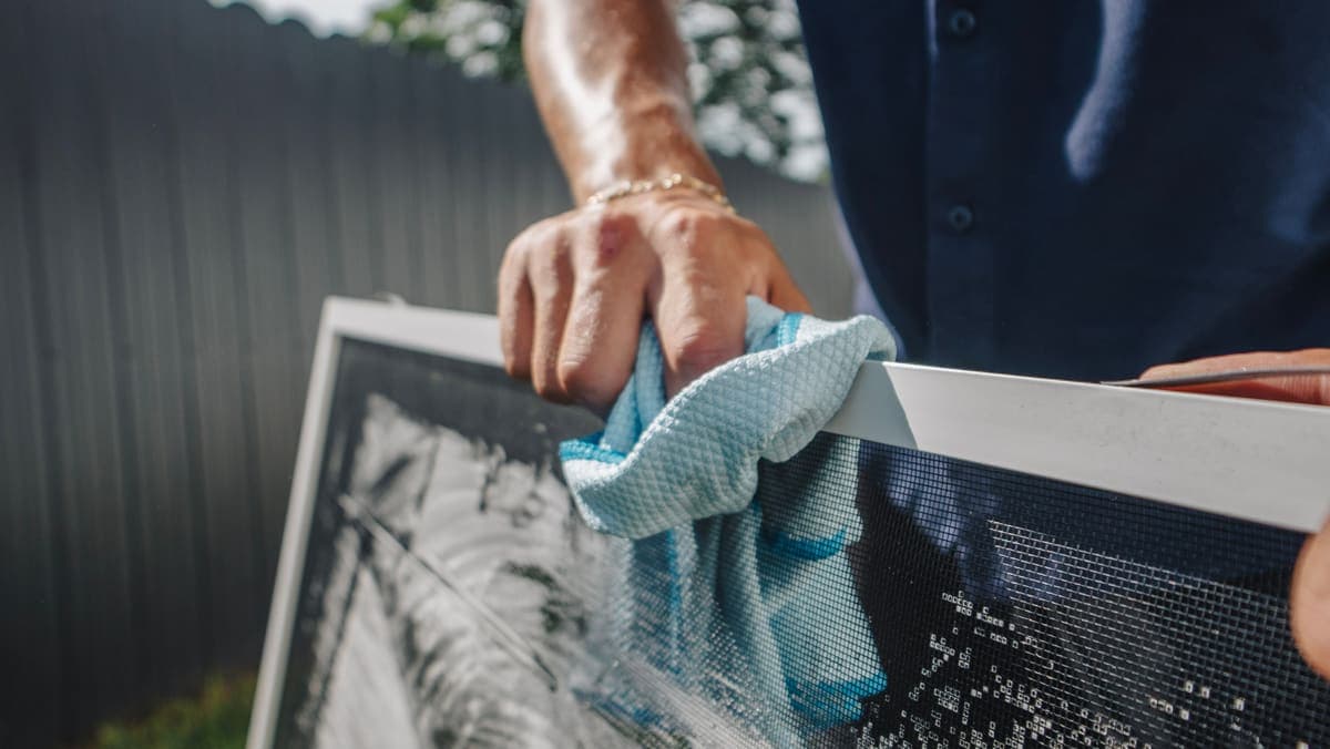 Drying a removed window screen with a microfiber towel